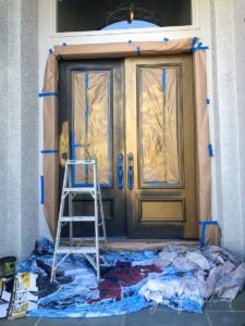 greenish-gold front door being painted