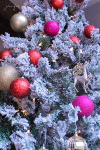 beautiful red, fushcia, gold, and silver ornaments on a themed christmas tree by jennifer allwood