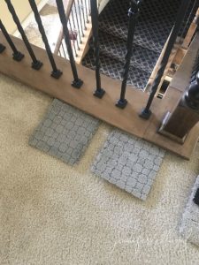 two carpet samples next to stairs
