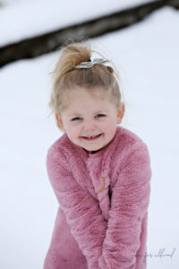 little girl smiling in the snow