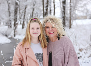 mother and daughter smiling in the snow