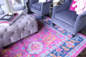 closeup view of fuschia, blue, and orange living room rug by jennifer allwood