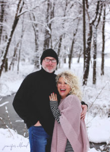 husband and wife laughing in the snow