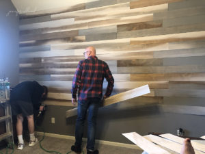 father and son making progress on the wood wall project in jennifer allwood's home