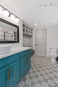 Bright and Modern Bathroom with Geometric Tile and Blue Cabinets