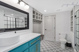 Bright and Modern Bathroom with Blue Cabinets and Rectangular Mirror