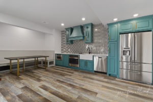 Basement Kitchen Remodel with Bright Blue Cabinets and Geometric Tile Backsplash