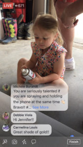 Little girl learning how to spray paint