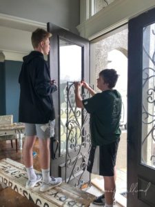 teen boys removing iron from front door