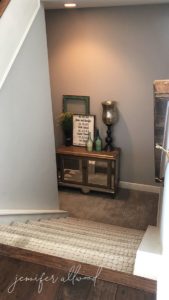 stair walkway with buffet table and picture frames