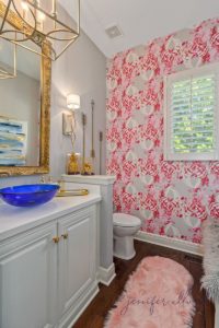 bathroom wallpaper with gold chandelier and blue sink