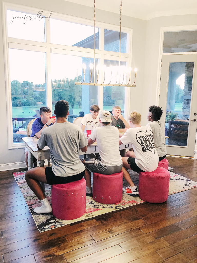 Teen football guys sitting at table 