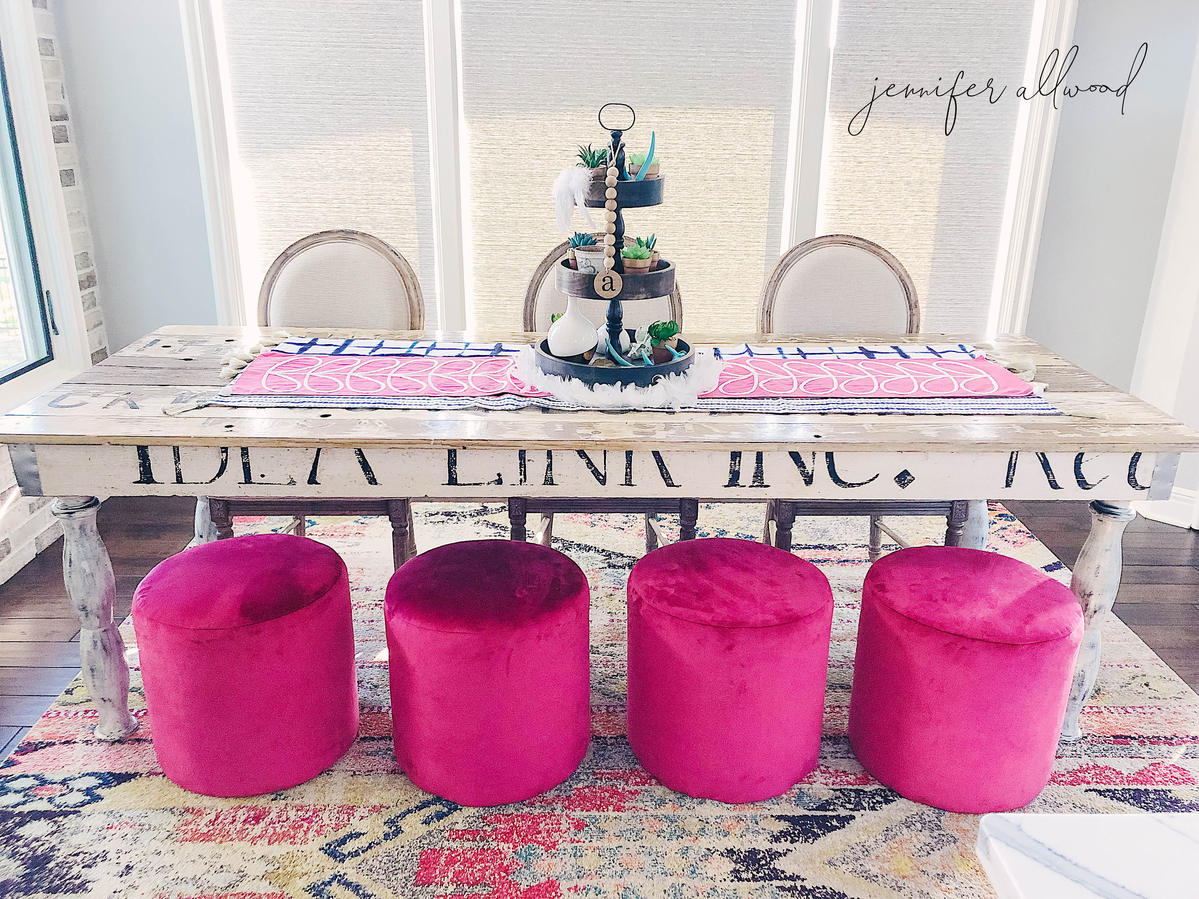 Chic Farm Table with Glamorous Pink Ottomans